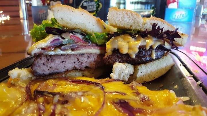 a big country melt burger cut in half at Cedar Rock Grill